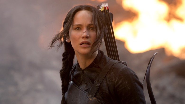 Katniss looking off with fire behind her